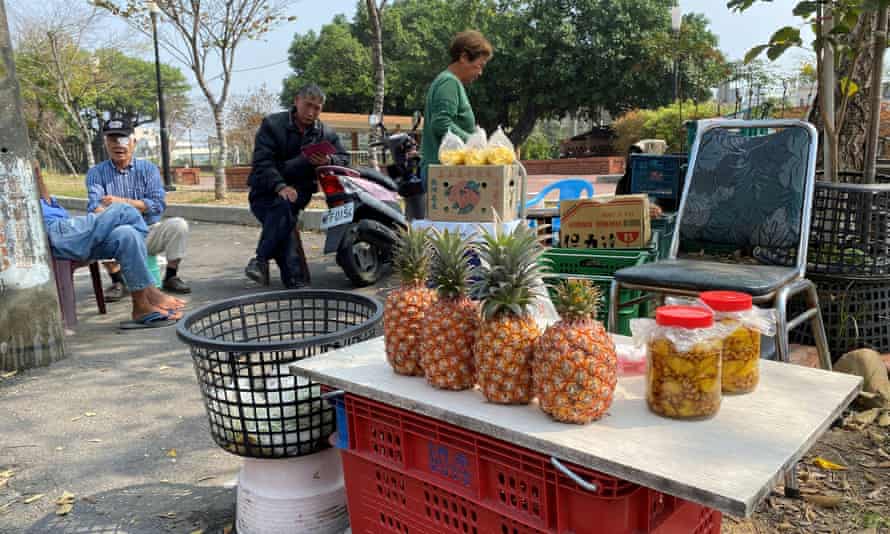 Farmers selling pineapples at a stall by the road in Kaohsiung, Taiwan