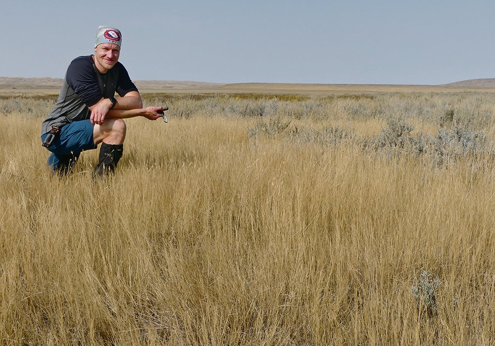 Timm Döbert uses GPS on a grassland field exploration expedition while conducting research in rotational adaptive grazing management. 