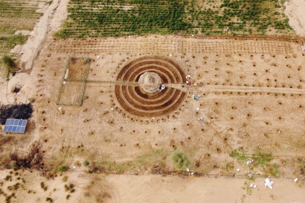 An aerial view shows participants of a Tolou Keur programme working on a newly built Tolou Keur garden in Boki Diawe, within the Great Green Wall area, in Matam region, Senegal, July 10, 2021.