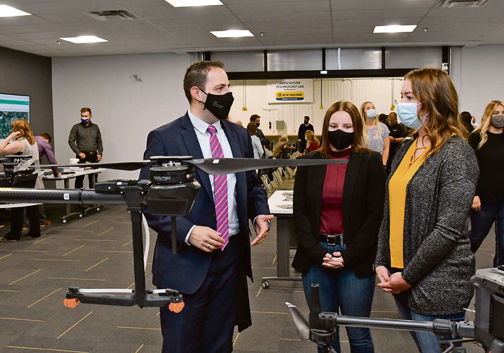 Minister of Advanced Education Demetrios Nicolaides learns about the latest drone technology in agriculture during the opening of the new degree program at Lakeland College. 