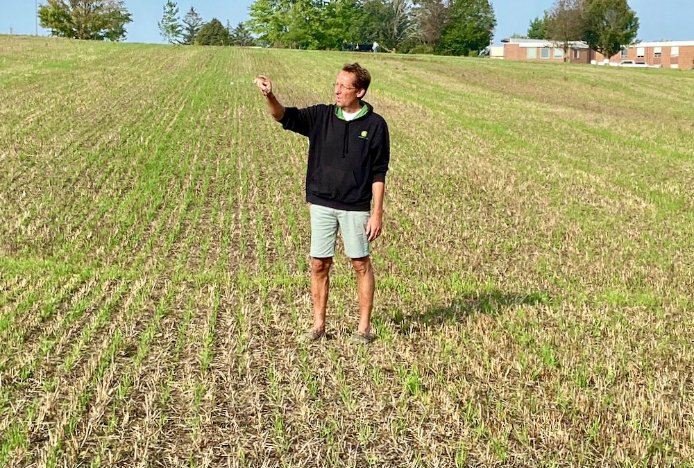 Rick Koostra shows where a significant cut once went through this field but was remediated by tile drainage and rip rap placed at the field edges where water enters.