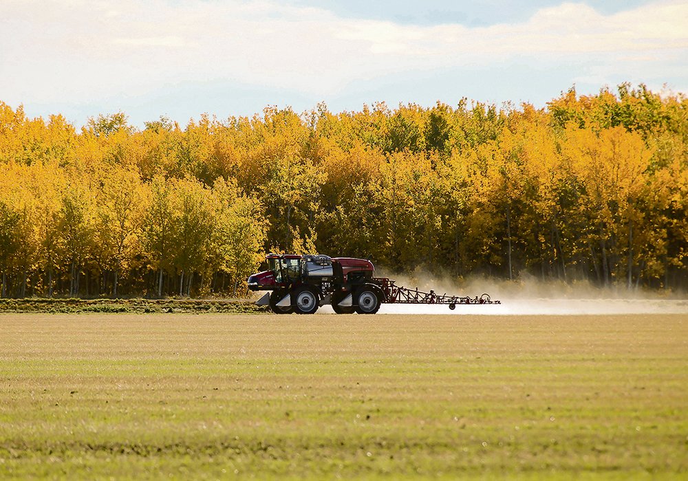 A farmer takes advantage of a wind-free late September morning to spray a field east of Kleskun Hills Park near Bezanson, Alta. Warm conditions mean fall weed control is effective and a lot cheaper than it will be in the spring, as glyphosate prices are predicted to rise through the winter.  