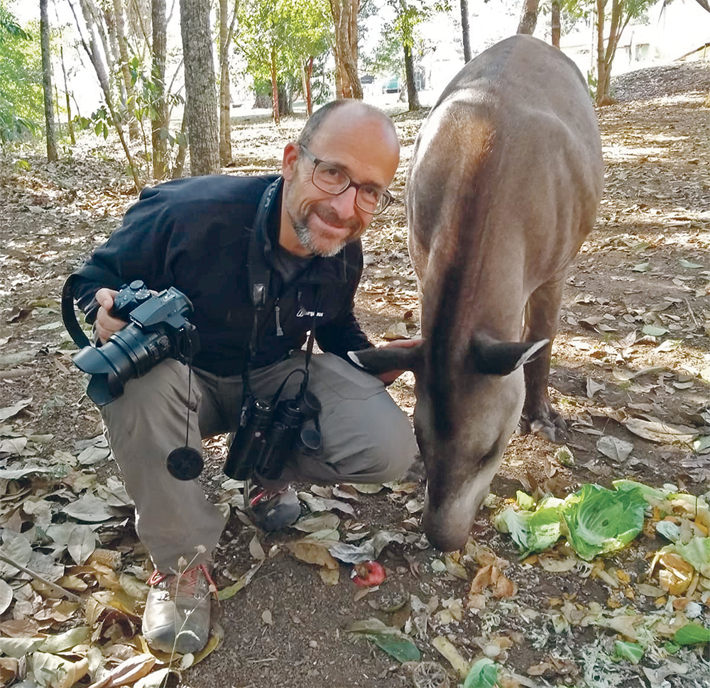 Andrew Balmford with ‘Preciosa’, a hand-reared lowland tapir in Emas National Park, Brazil. 