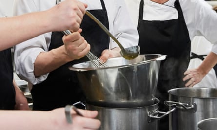 Teacher assists cookery students