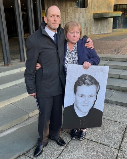 Stuart and Jill Atkinson holding a photo of their son James.