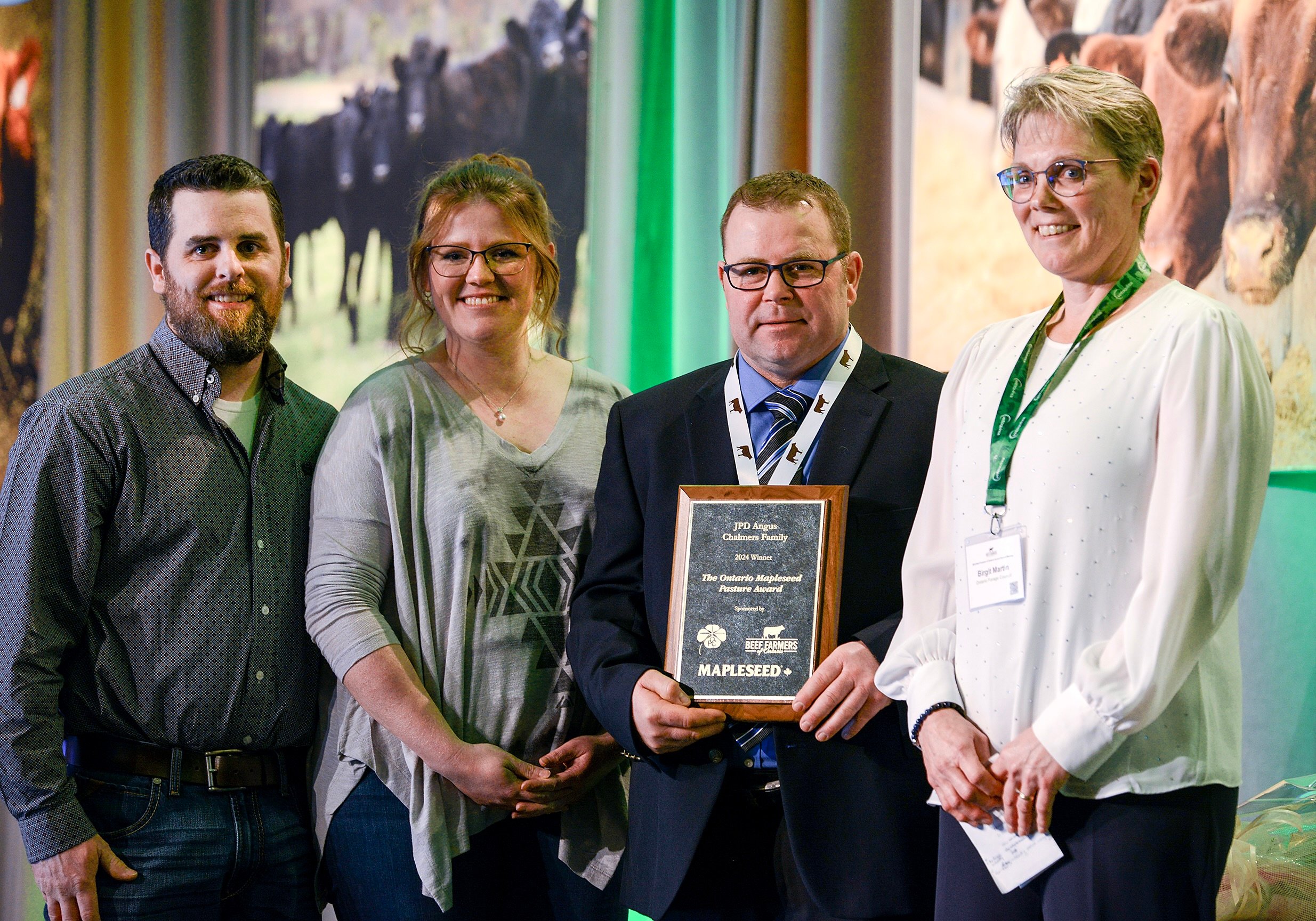 Michaela and Chris Stoneman, left, accept the Beef Farmers of Ontario Mapleseed Pasture Award on behalf of JPD Angus in Oro-Medonte for their environmental improvements and exceptional pasture management from Scott Fisher, Mapleseed and Patricia Ellingwood, Ontario Forage Council.