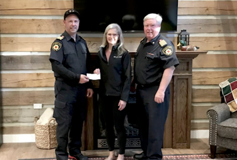 Warwick Fire Department Deputy Chief Kameron Turner, left, and Chief Brad Goodhill present Diane Bergsma, centre, with a cheque for $4,000 from a 50/50 draw and local donations at the Warwick pancake breakfast.