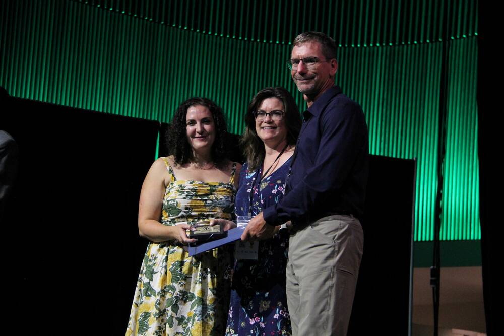 Cutline: John Duynisveld and his wife, Jane, accept the TESA from Kelleen Tait. Photo: Melissa Jeffers-Bezan
