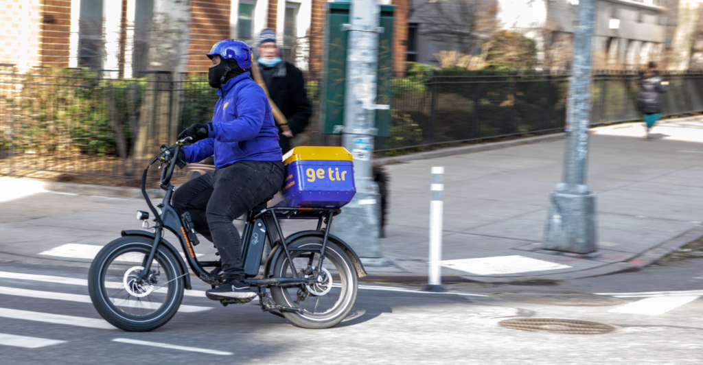 A Getir instant food delivery employee rides a bike near Washington Square Park.png