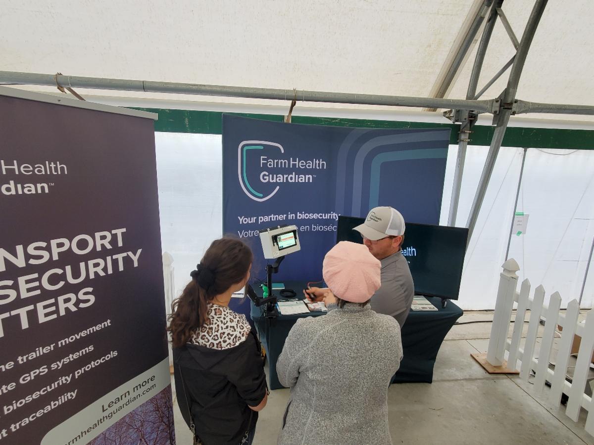 Demonstrating Farm Health Guardian's Protocol facial recognition controlled barn entry system at Canada's Outdoor Farm Show in 2023.