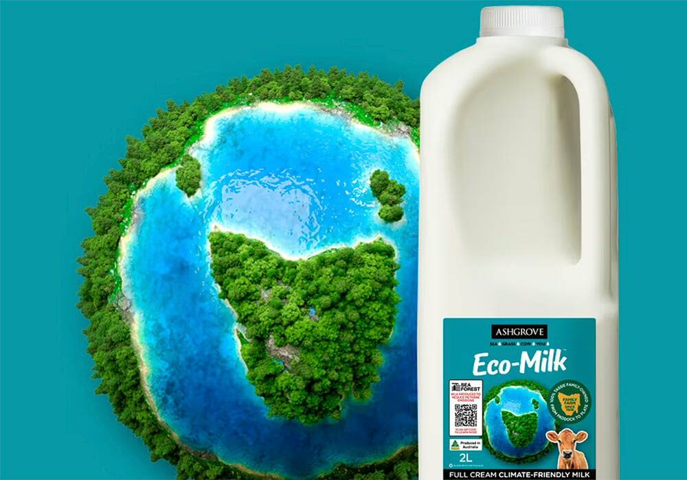 A bottle of Eco-Milk with an animated globe in the background with continents populated with trees.