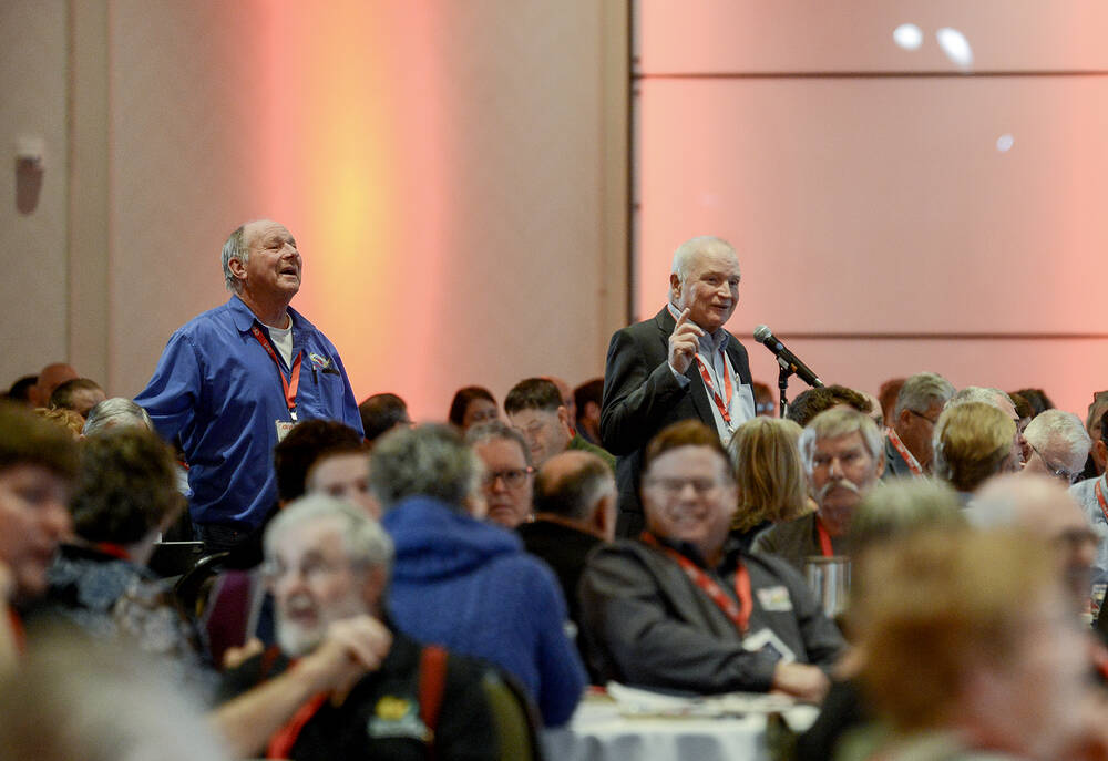 Ron Bonnett, right, past OFA and CFA president, clarifies aspects of his resolution asking for a proactive response to President-elect Donald Trump's proposed 25 per cent tariff on Canadian goods during the Ontario Federation of Agriculture's general meeting in Toronto Nov. 26. 