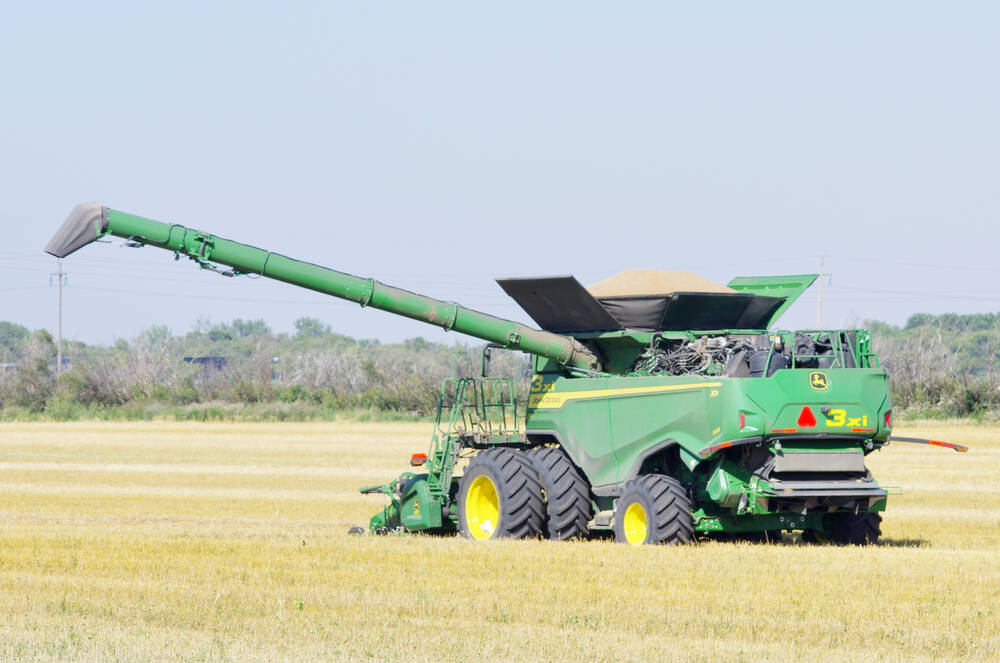 A loaded combine waits for the grain truck to come around north of Winkler Sept. 2, 2024. 