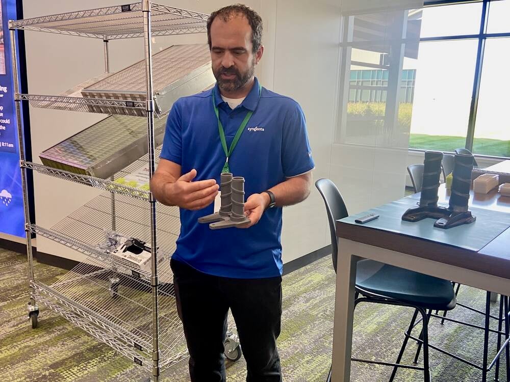 Judd Maxwell, Syngenta's head of North American Corn Product Placement, shows a model of the stock crusher used by the company to automatically measure standability of corn. 