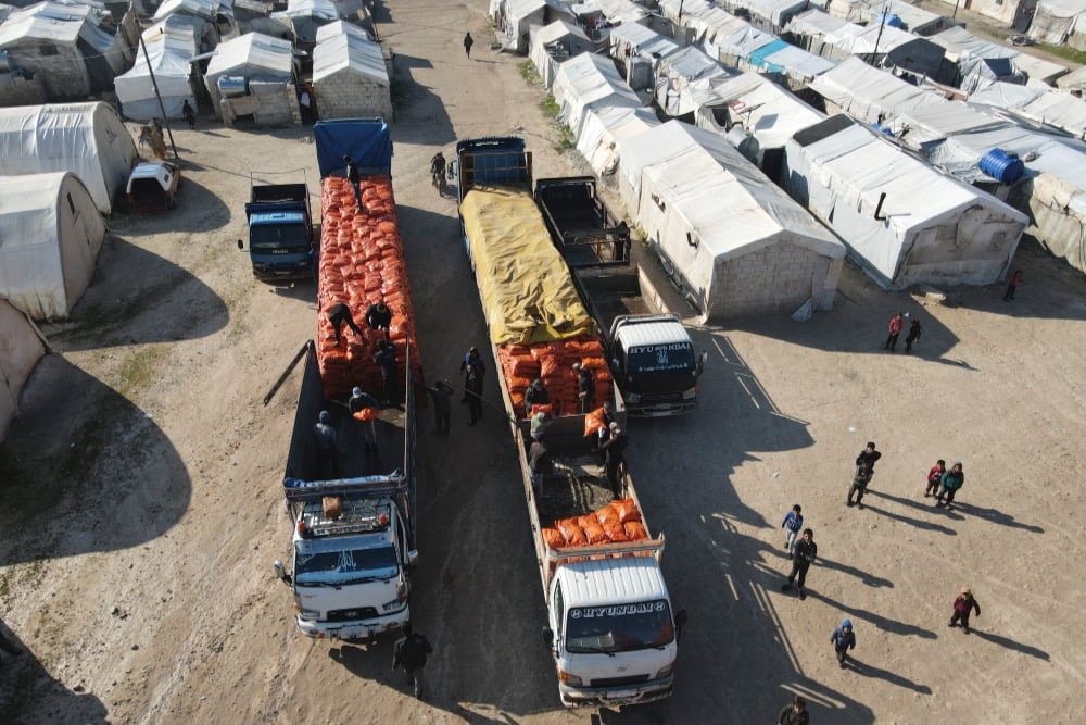 File photo: Humanitarian aid provided by Palestinian Arabs is distributed at northwestern Syria’s Deir Ballut and Muhammadiyah camps near the Turkish border on Feb. 13, 2022. (Photo: Rami Alsayed/NurPhoto via Reuters)
