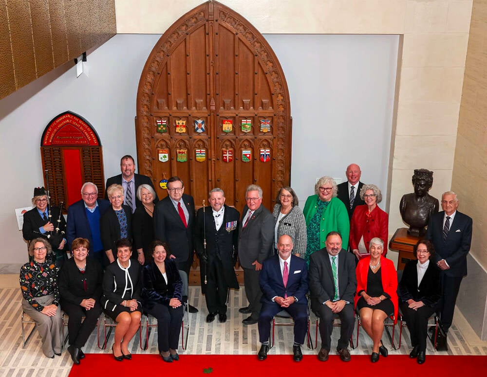 Ontario Senator Rob Black, back right of centre, and Prince Edward Island Senator Precy Downe, back left of centre, presented the King Charles III Coronation Medal at the Senate of Canada Chamber in November 2024.