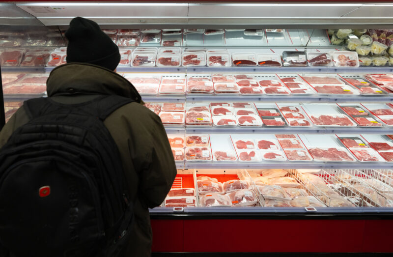 A shopper looks at meat in a grocery store in Montreal, Monday, Nov. 25, 2024. THE CANADIAN PRESS/Christinne Muschi