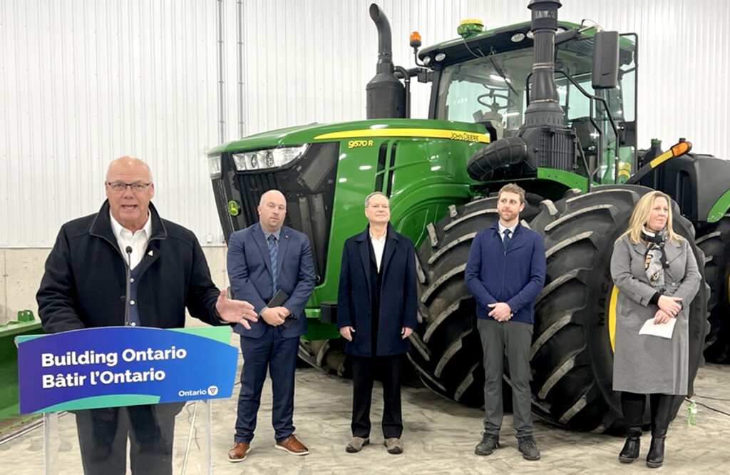 Rob Flack, Minister of Agriculture, Food and Agribusiness, left,  flanked by ag-sector representatives, announces a $100 million increase to the Risk Management Program over three years. Photo by Kristy Nudds