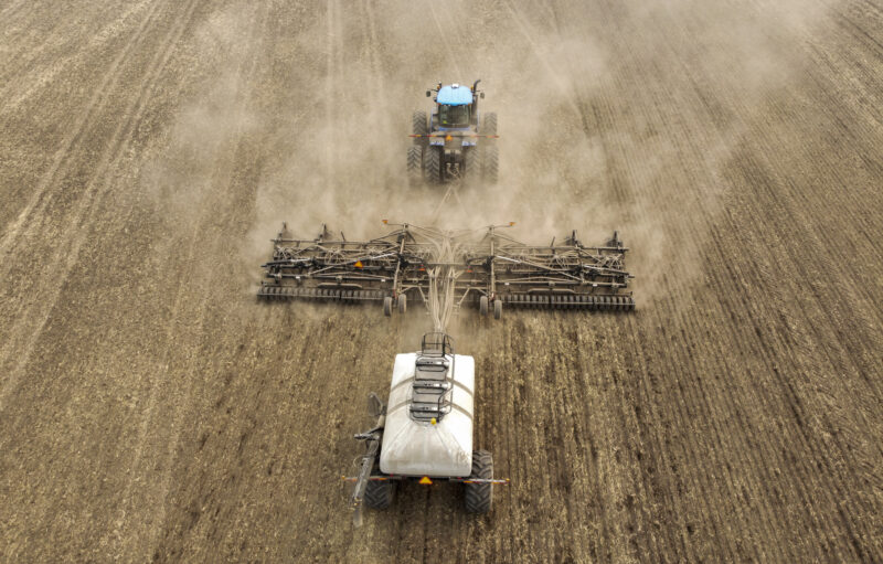 David Reid drives a seeding rig as he plants a canola crop on the family's farm near Cremona, Alta., Tuesday, May 16, 2023. THE CANADIAN PRESS/Jeff McIntosh