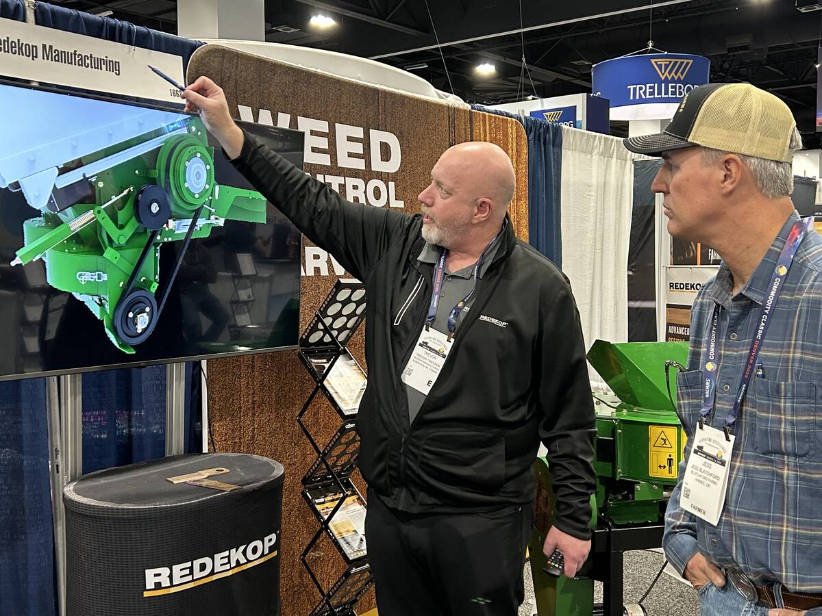 Trevor Thiessen of Redekop Manufacturing explains the company’s straw chopper to a farmer from Oregon at the Commodity Classic in Denver, Colorado, March 4. Redekop and other Canadian manufacturers are adjusting to 25 per cent tariffs on goods exported to the United States. | Robert Arnason photo
