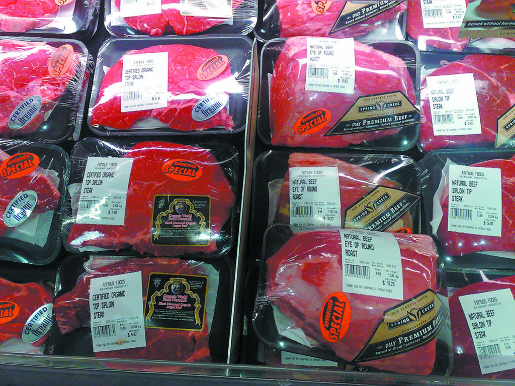 Organic beef is packaged and on display for sale at a meat shop.
