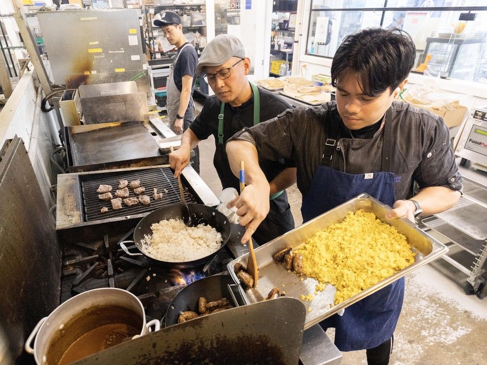 Chef T.J. Conwi, centre, with Pegie Embudo, right, and Daiki Ishikawa inside the Coho Commissary preparing food in Vancouver on April 29.
