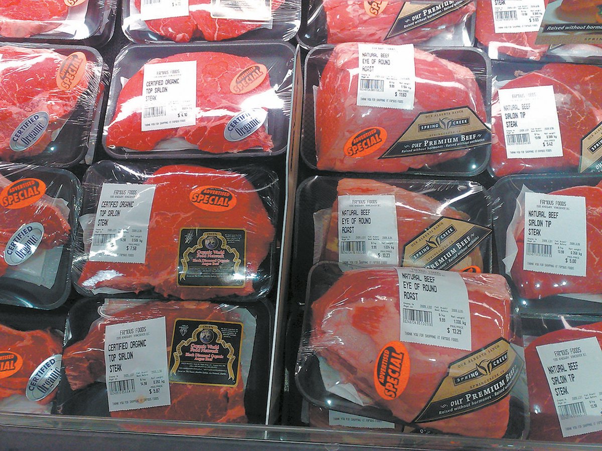 Organic beef is packaged and on display for sale at a meat shop.