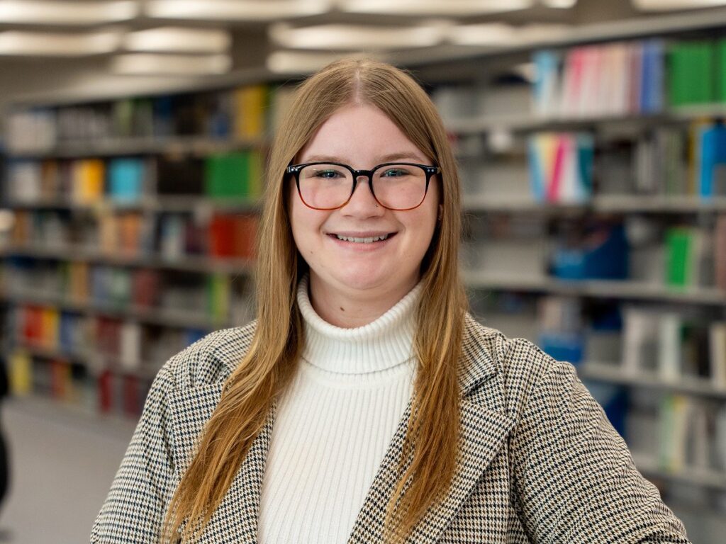 Brandon University chemistry student Kendal Giesbrecht poses for a photo in a library.