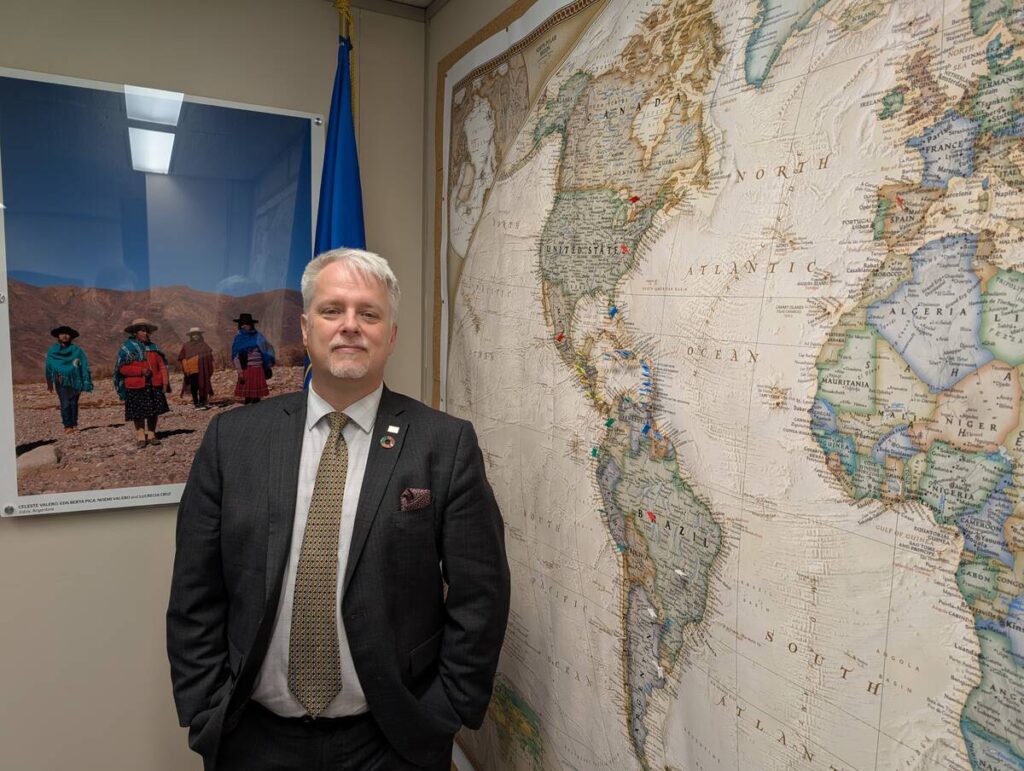 Jean-Charles Le Vall&eacute;e, Canada&rsquo;s Inter-American Institute for Cooperation in Agriculture country representative, stands in front of a large map of the world.