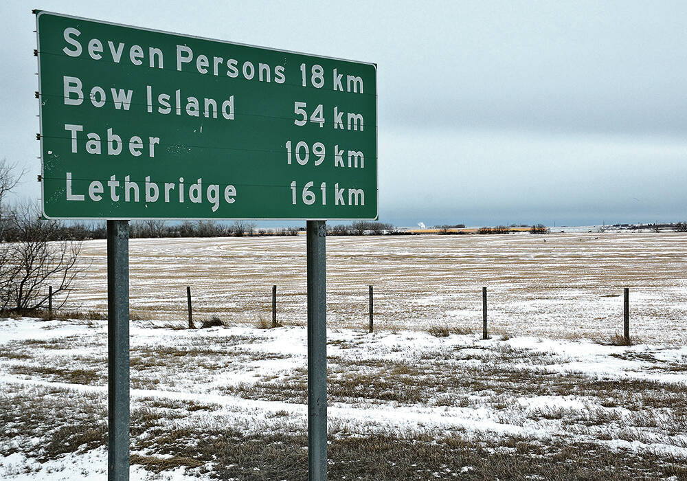 A green highway sign in Alberta with distances to Seven Persons, Bow Island, Taber and Lethbridge.