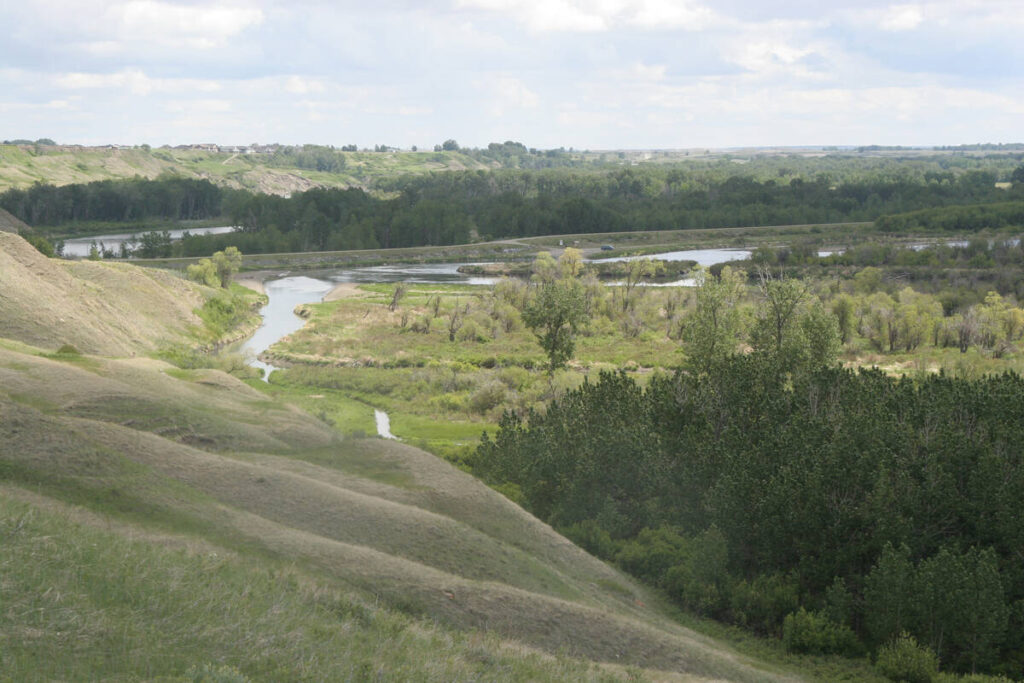 A river meanders through a lush green valley.