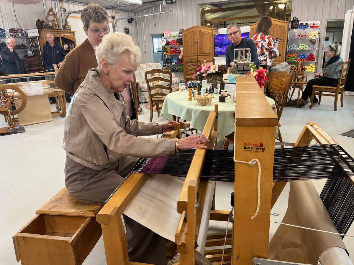 Saskatchewan Lt.-Gov. Bernadette McIntyre tries out a weaving loom at Canadian Fibre Mill