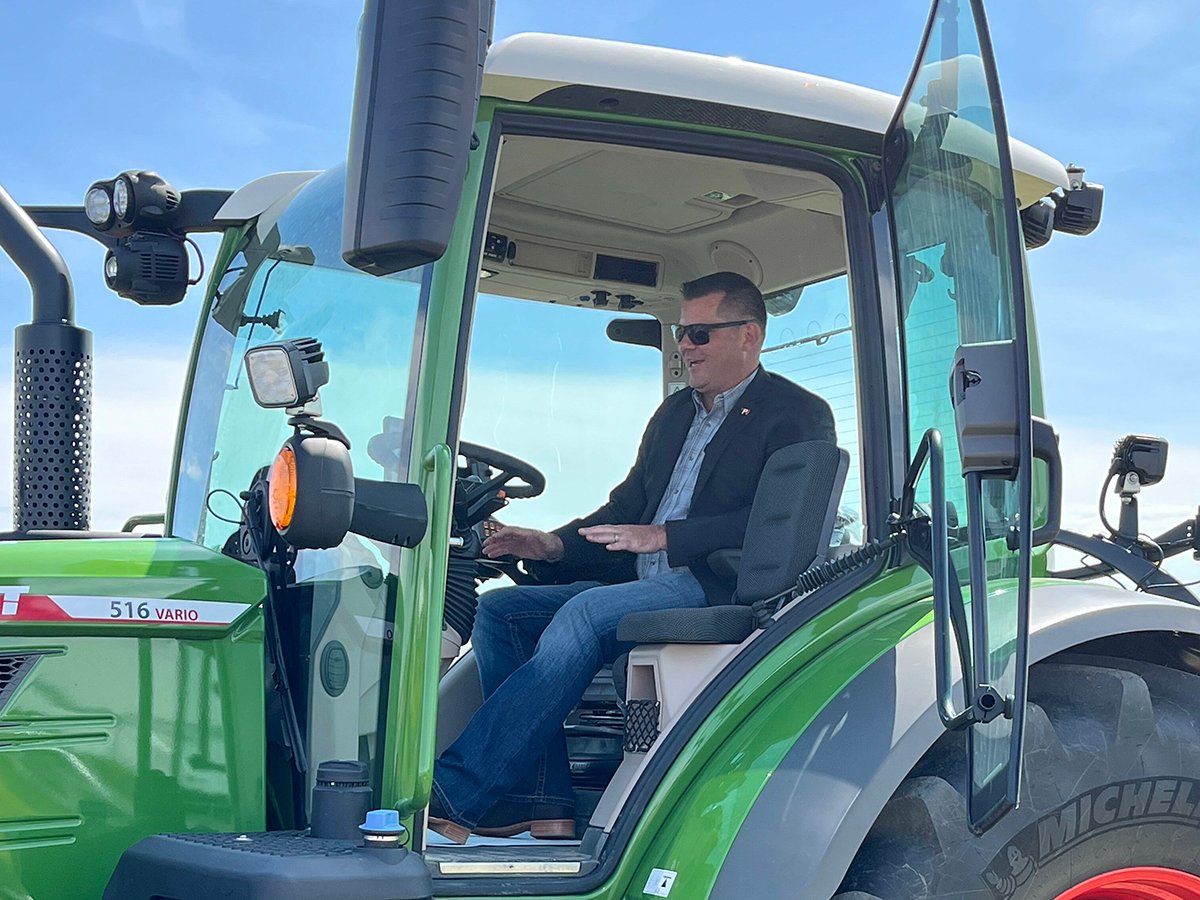 Alberta Minister of Agriculture and Irrigation RJ Sigurdson sits in a tractor at a funding announcement at Farming Smarter near Lethbridge.