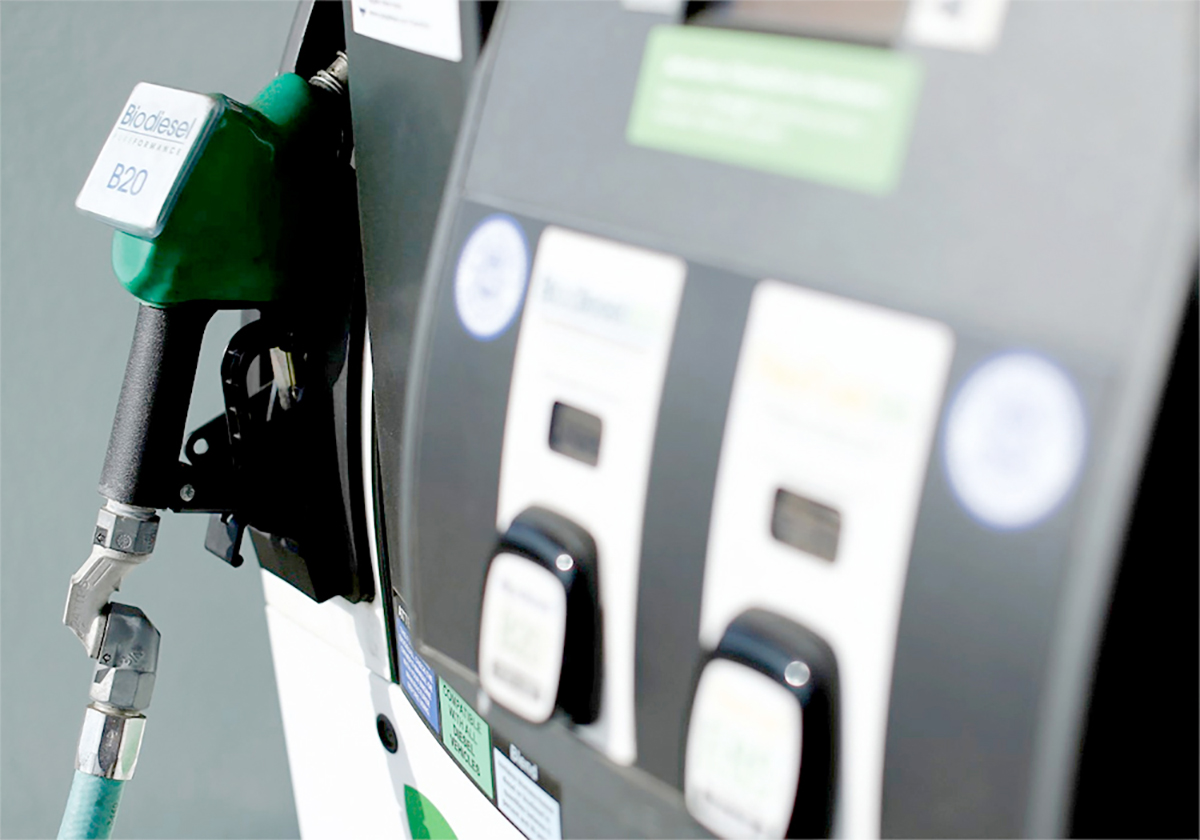 Close-up of the options on a fuel pump with the nozzle secure in its holder in the background.