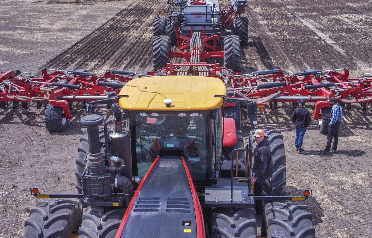 Steve Rooke of Shark Farms Ltd. near Nanton, Alta., climbs onto to his tractor pulling a Morris Quantum 60 drill and tank during a recent demonstration of Morris seeding equipment organized by Viterra near High River, Alta. Seeding was 90 per cent complete in Alberta as of May 27, ahead of the five-year average of 81 per cent. Photo: Mike Sturk
