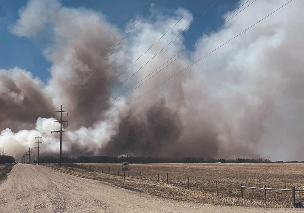Smoke rises high into the sky from a wildfire 500 meters away.