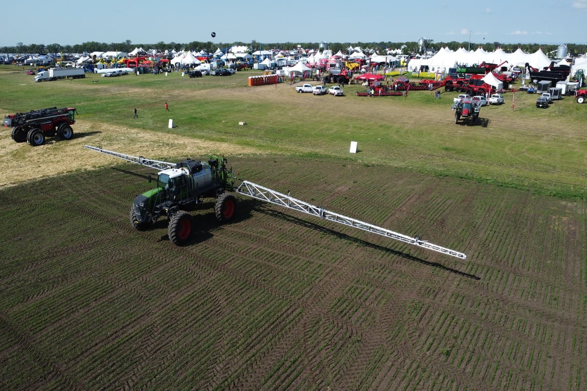 A sprayer sitting in a large field at Ag in Motion.