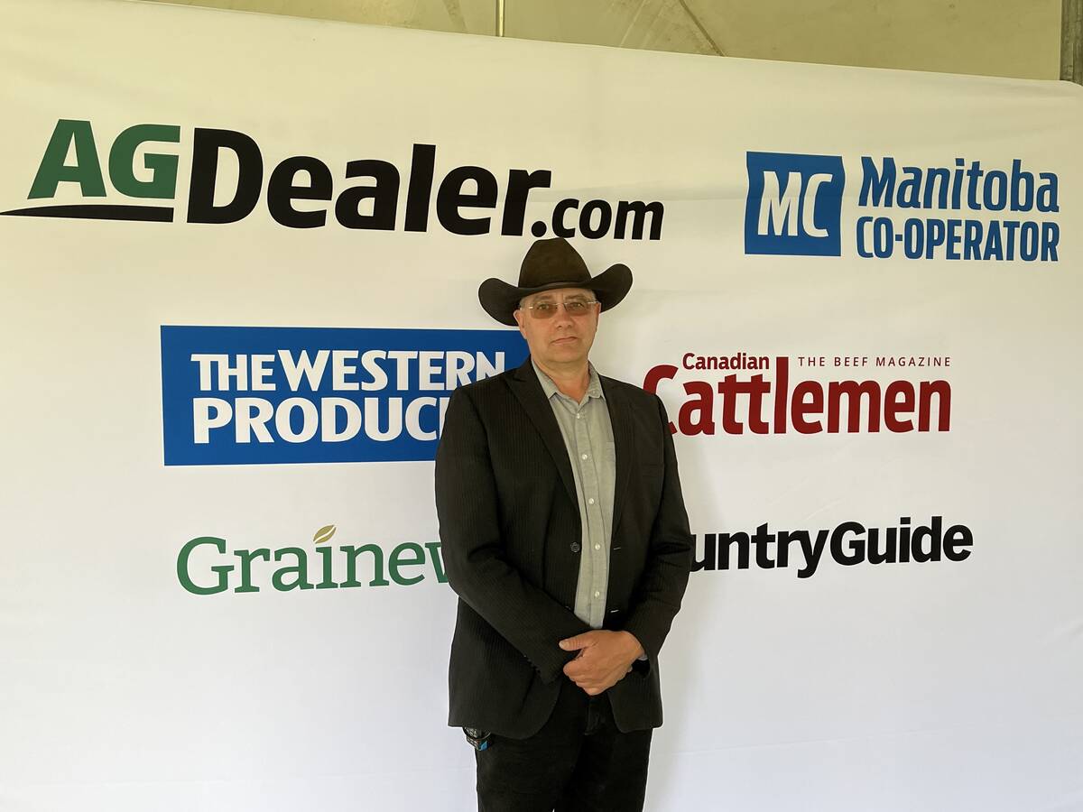 Rob O'Connor, show director for Ag in Motion 2025 poses in front of a Glacier FarmMedia banner.
