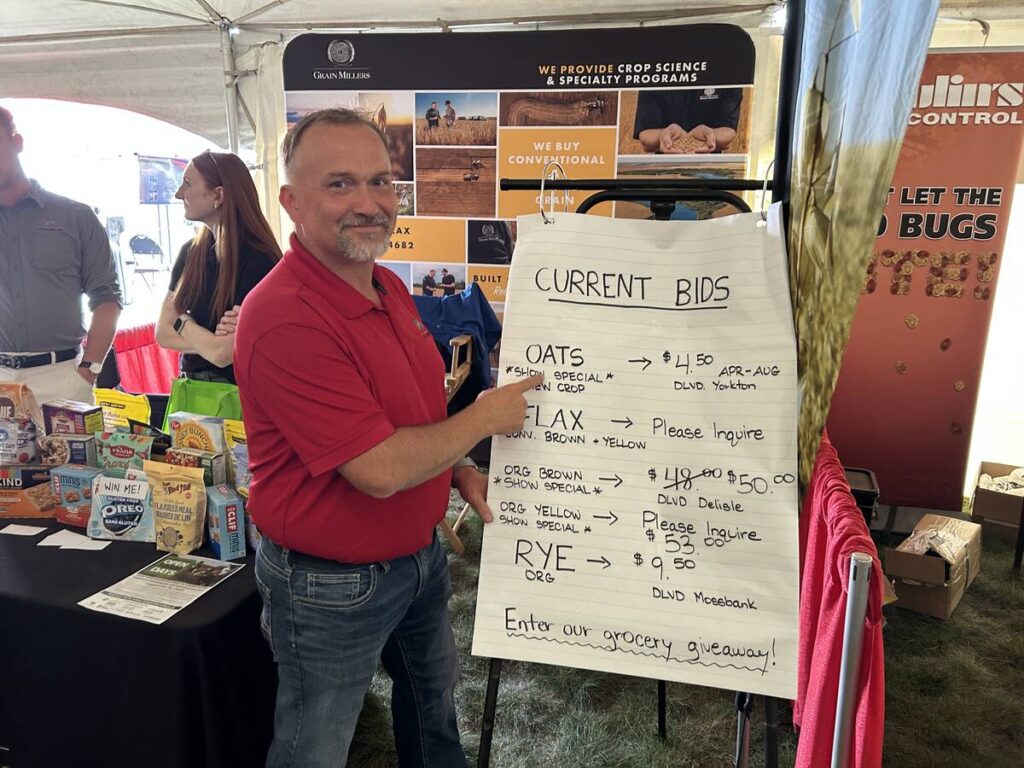 Scott Shiels, grain procurement manager for Grain Millers, shows the company&rsquo;s current new crop bid at the Ag in Motion 2025 show near Langham, Sask.