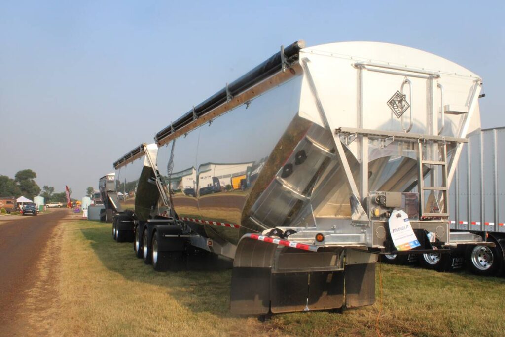 A polished, aluminum grain trailer on display at the Ag in Motion Farm show near Langham, Saskatchewan, in July of 2025.