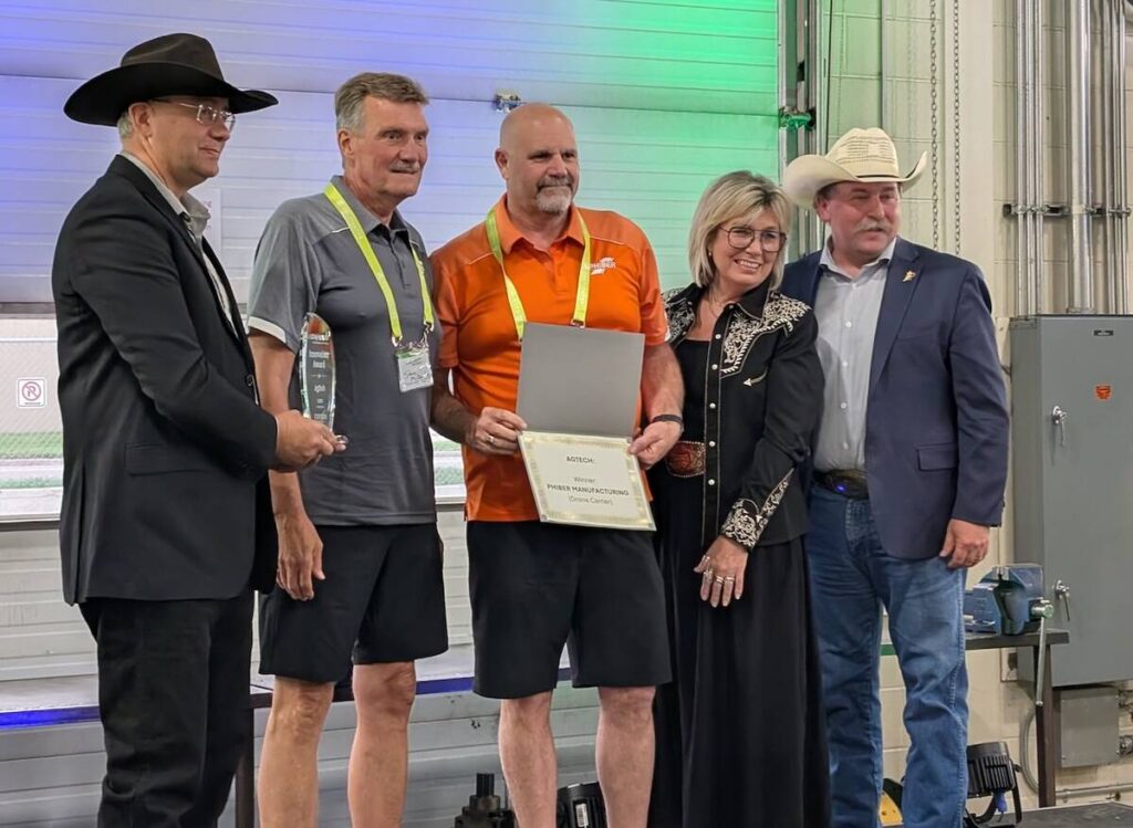 PhiBer Manufacturing won the AgTech innovation award for its drone carrier at the Ag in Motion innovation program, with Saskatchewan Minister of Agriculture Daryl Harrison, right, presenting the award.