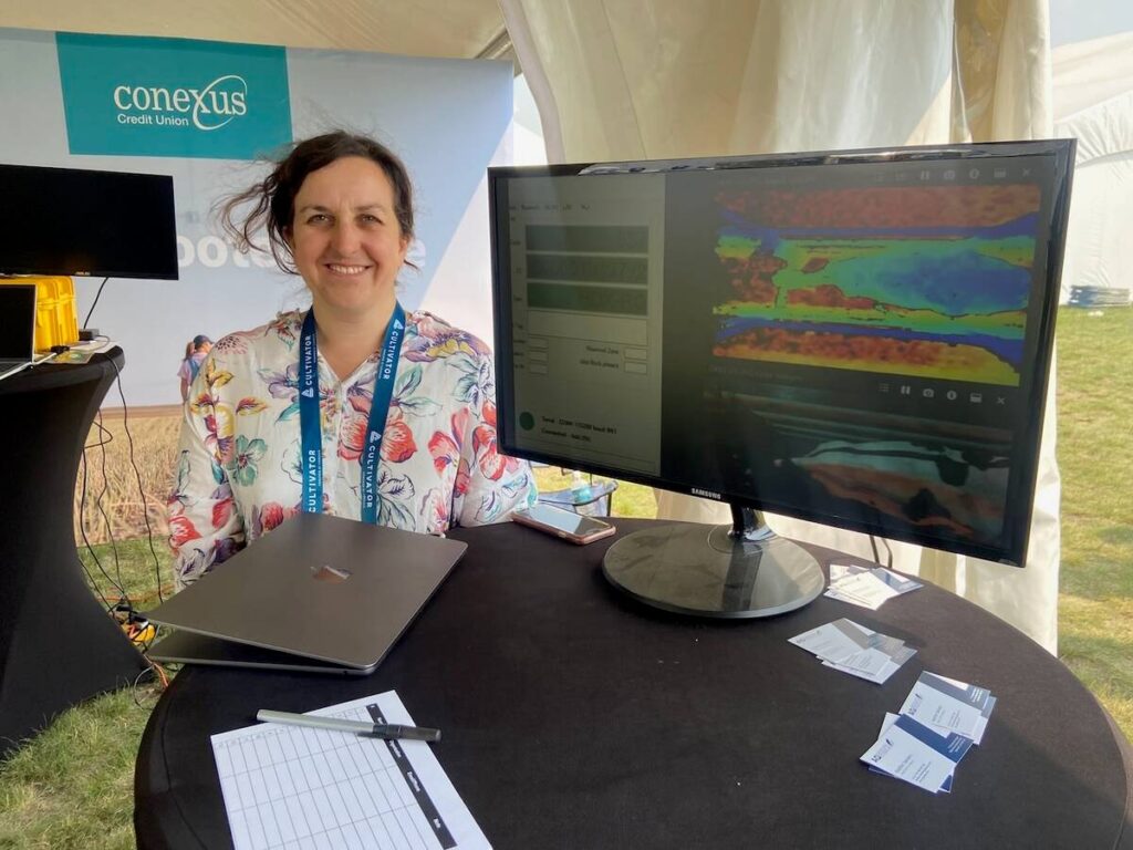 Heather Sanders of AgSenze stands in front of a computer display of her company