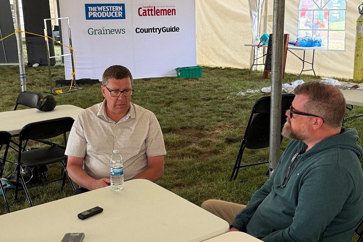 Scott Moe, left, talks to Western Producer reporter Sean Pratt at the Ag in Motion farm show near Langham, Saskatchewan. Photo: Paul Yanko
