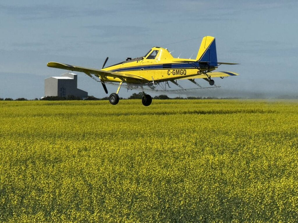 Spraying canola just east of Delisle, Sask
