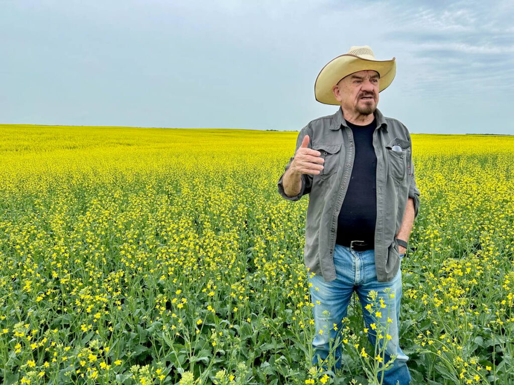 Robert Andjelic, who owns 248,000 acres of cropland in Canada, stands in a massive field of canola south of Whitewood, Sask. Andjelic doesn