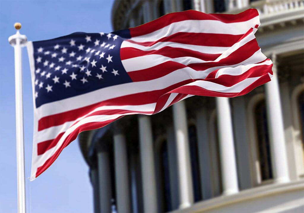 The American flag flies in front of the Capitol Building in Washington.