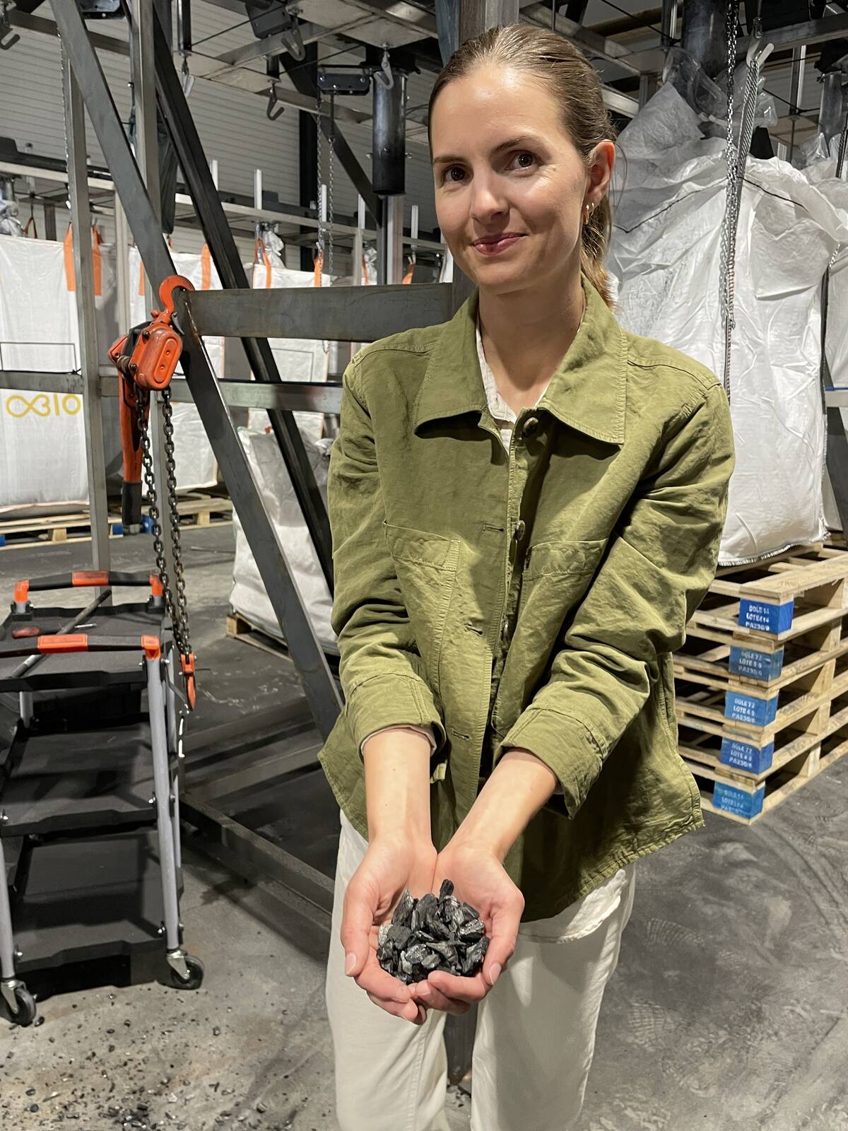 Kristina Alme Gardli, product development lead with Obiochar in Norway shows the company's biochar product which is being used to enhance animal and soil health. Photo: Lilian Schaer 