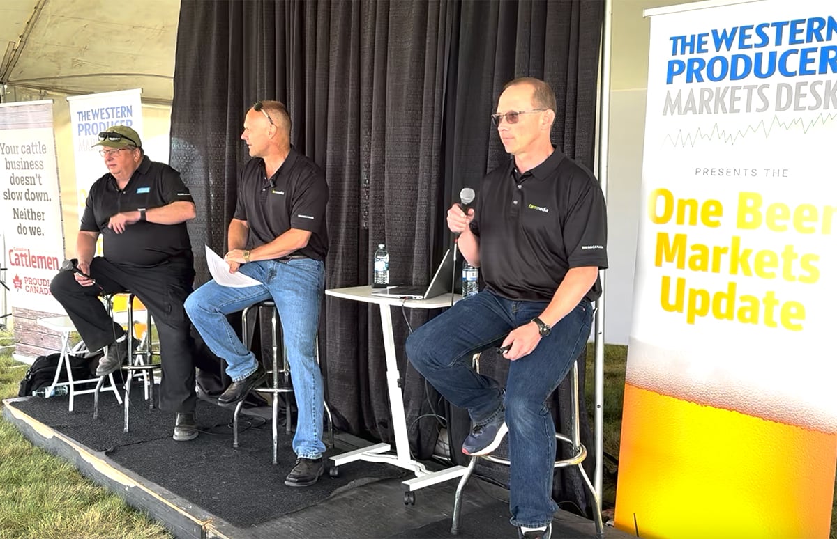 Left to right: Bruce Burnett, Jerry Klassen and Ranulf Glanville talk markets at the Ag in Motion farm show near Langham, Sask.