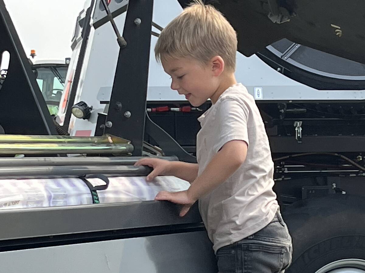 Photo by Greg Price
Three-year-old Liam Hrappstead gets a closer look at a Massey Ferguson round baler at Ag in Motion 2025.