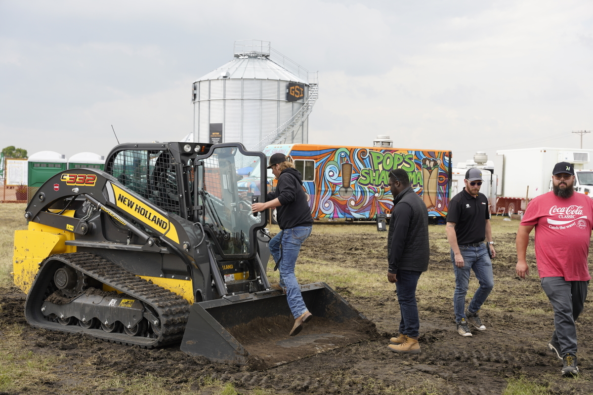 Ag in Motion visitors trying a New Holland tractor.